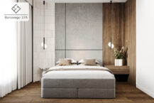 Sypialnia w mieszkaniu na sprzedaż w Krakowie, przy ulicy Piotra Borowego z dużym, wygodnym łóżkiem. Ściany ozdobione są stylowymi panelami, łączącymi drewno z jasnymi elementami.  